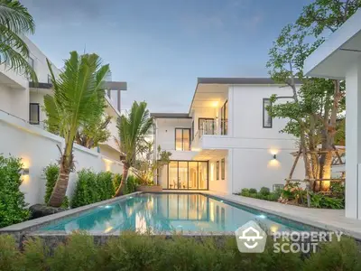 Luxurious modern villa with a sparkling pool, lush landscaping, and a serene ambiance, perfect for upscale living and entertaining.