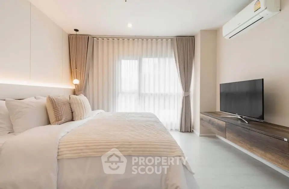 Spacious modern bedroom with elegant decor and natural light