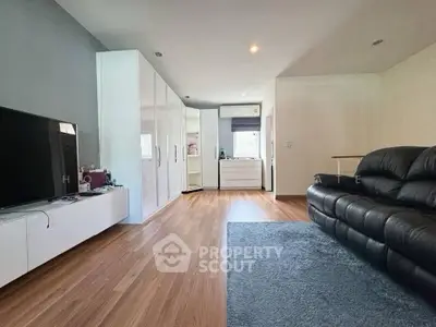 Spacious living room with modern decor and sleek wooden flooring