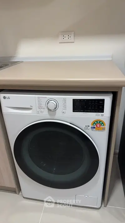 Modern laundry area with energy-efficient washing machine in sleek interior design.