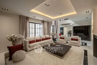 Luxurious modern living room with elegant decor and spacious seating area.