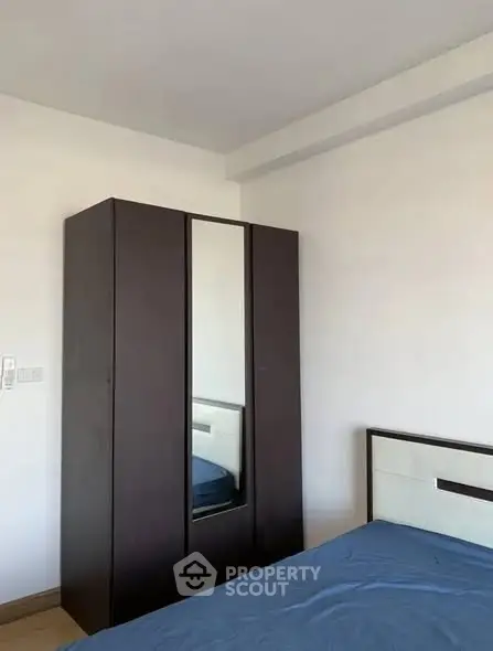 Minimalist bedroom with sleek wardrobe and bed, perfect for modern living.