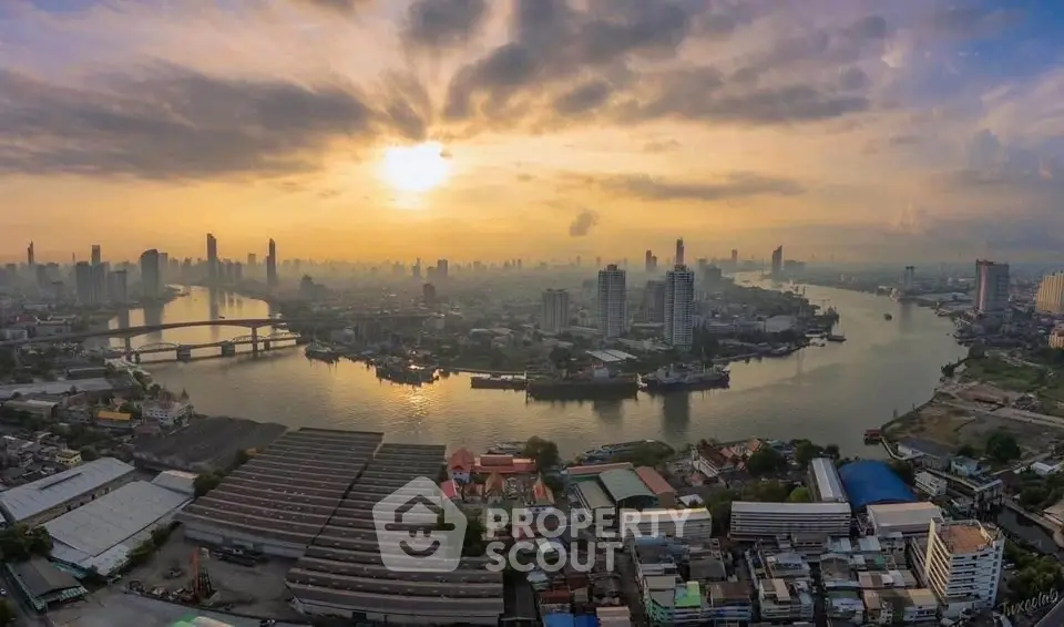 Stunning aerial view of city skyline and river at sunset, showcasing urban landscape and architectural beauty.