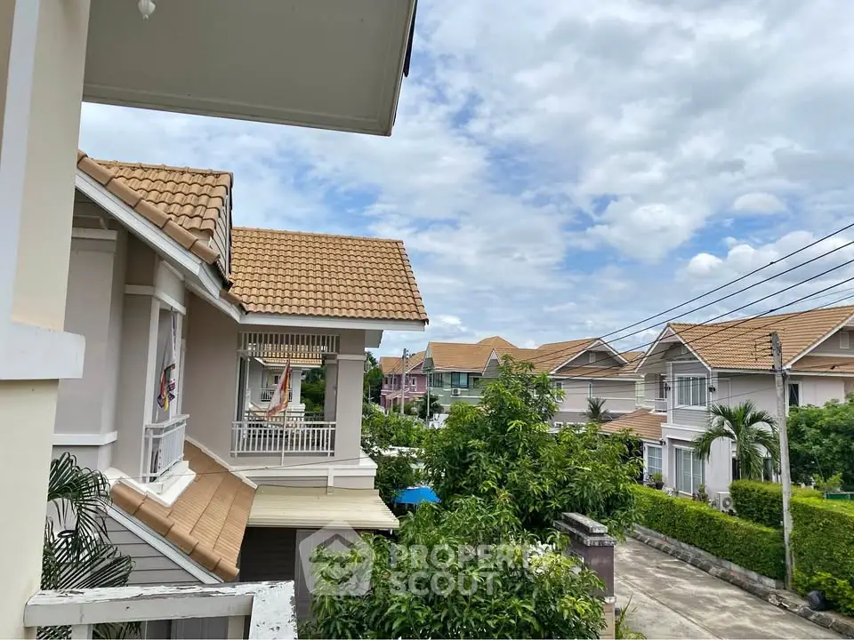Charming suburban neighborhood with modern houses and lush greenery under a clear blue sky.