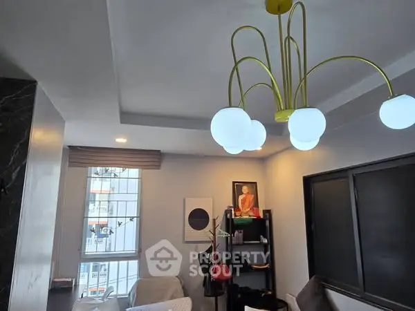 Stylish living room with modern chandelier and large window view
