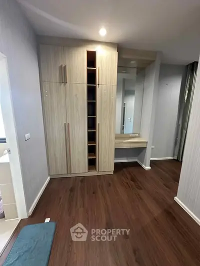 Modern bedroom with wooden flooring and built-in wardrobe
