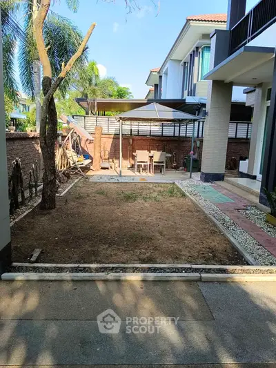Charming backyard with patio and garden space in a modern residential property.