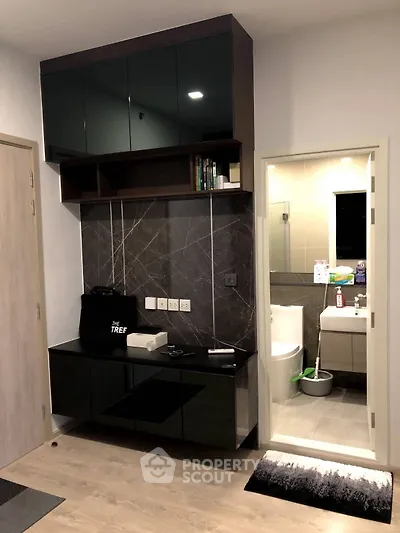 Modern apartment interior with sleek storage and bathroom view