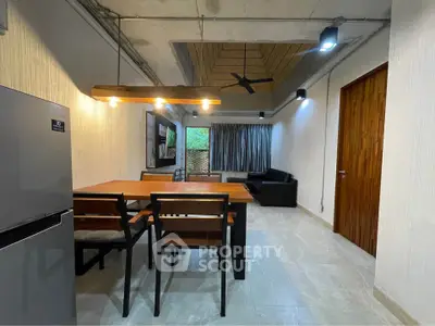 Modern dining area with stylish lighting and open layout in contemporary apartment.