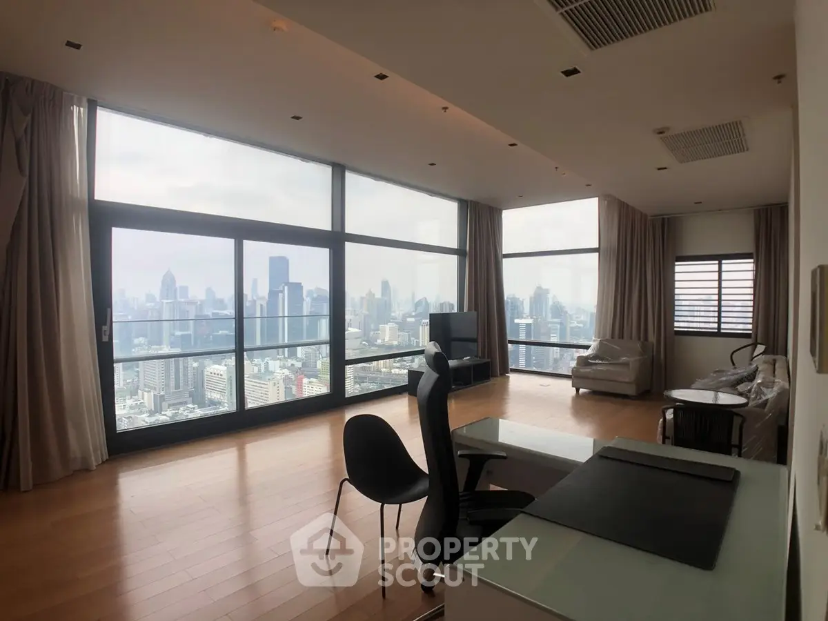 Spacious modern living room with panoramic city views and elegant furnishings.