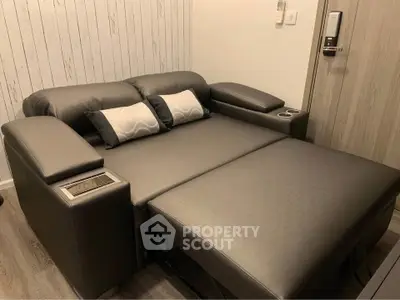 Modern living room with sleek black leather sofa bed and stylish decor.