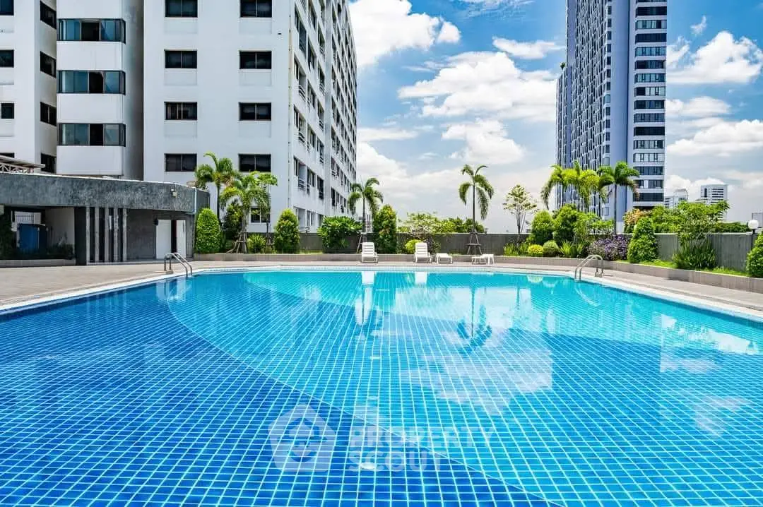 Luxurious rooftop pool with cityscape views and modern high-rise buildings.