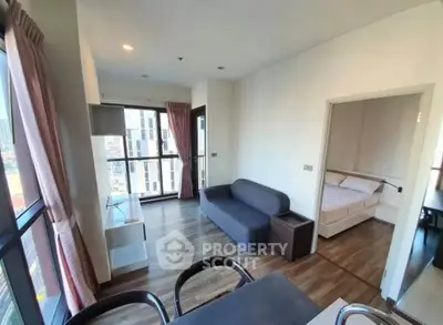 Modern apartment interior with spacious living room and cozy bedroom, featuring large windows and stylish decor.