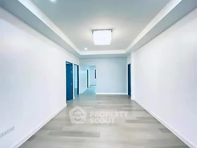 Spacious modern living room with sleek flooring and recessed lighting