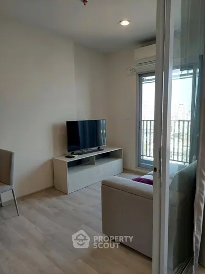 Modern living room with balcony view and sleek TV setup