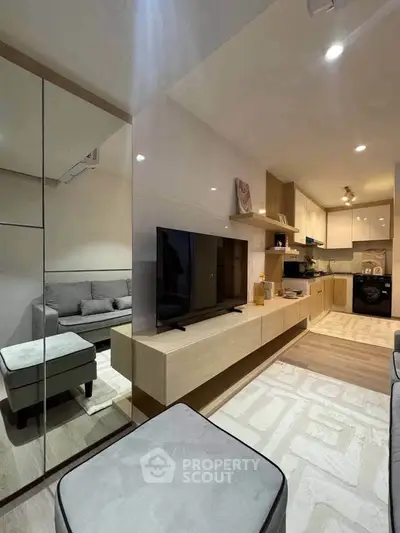 Modern living room with sleek design, featuring a cozy seating area and stylish kitchen in open layout.