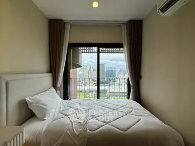 Cozy bedroom with city view and balcony access in modern apartment