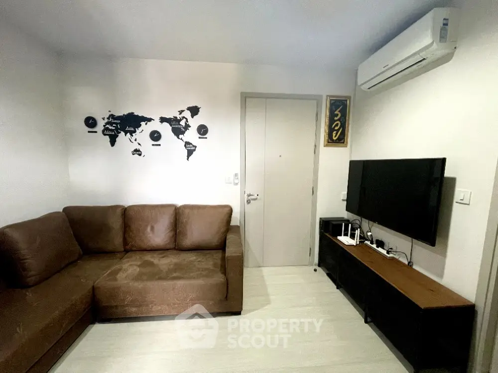 Cozy living room with brown sofa, wall art, and modern entertainment setup