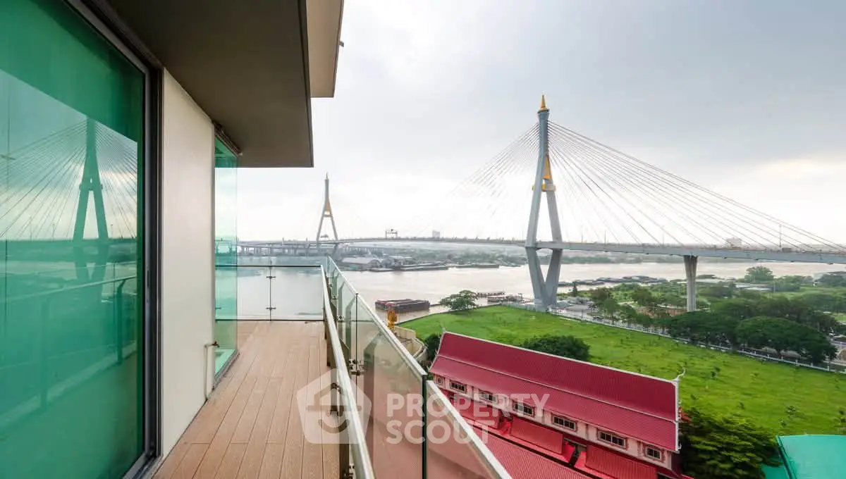 Stunning balcony view of iconic bridge and river, perfect for urban living enthusiasts.