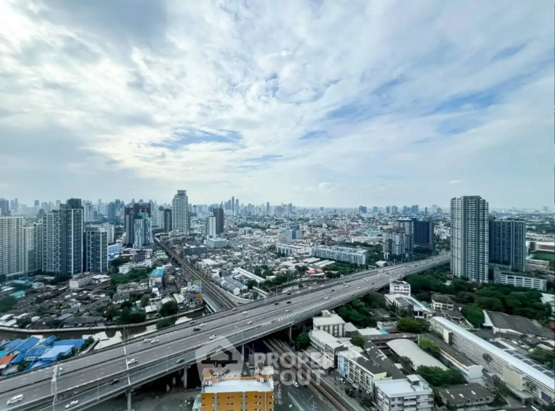 Stunning cityscape view from high-rise building showcasing urban skyline and highways.