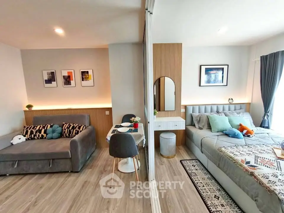 Modern studio apartment with stylish decor, featuring a cozy living area and comfortable bedroom.