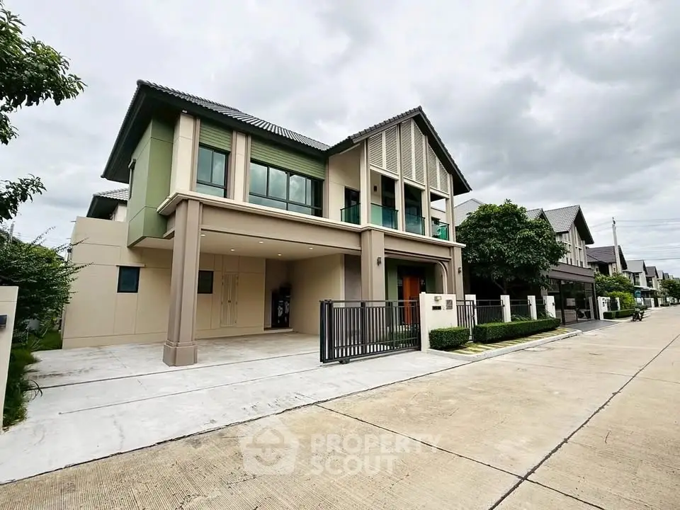Modern two-story house with spacious driveway and lush greenery in a serene neighborhood.