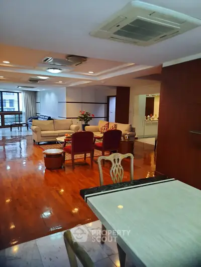 Spacious living room with elegant wooden flooring and modern furniture