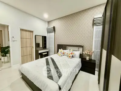 Modern bedroom with stylish decor and cozy ambiance, featuring a comfortable bed and elegant furnishings.