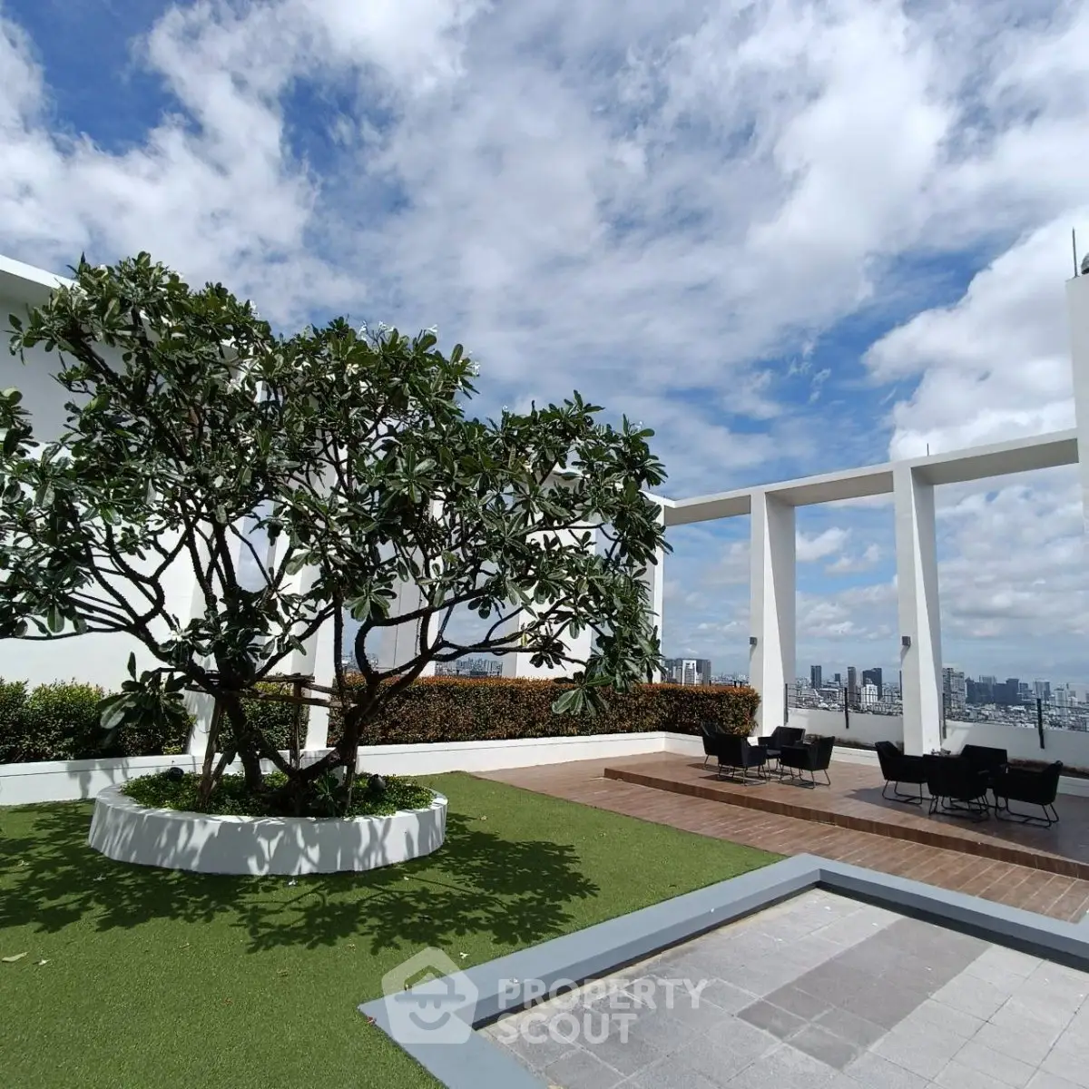 Stunning rooftop garden with panoramic city views and modern seating area.