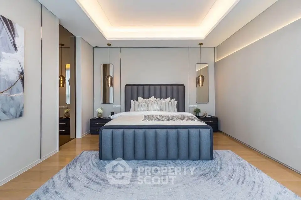 Luxurious modern bedroom with elegant decor and ambient lighting, featuring a plush bed and stylish furnishings.