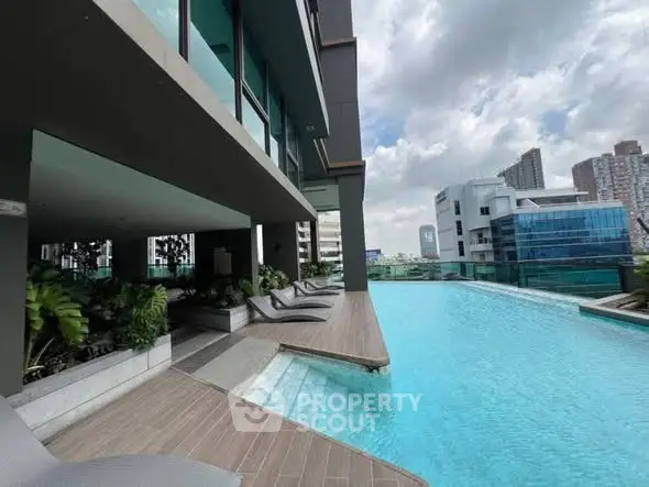Luxurious rooftop pool with city skyline views and modern lounge chairs.