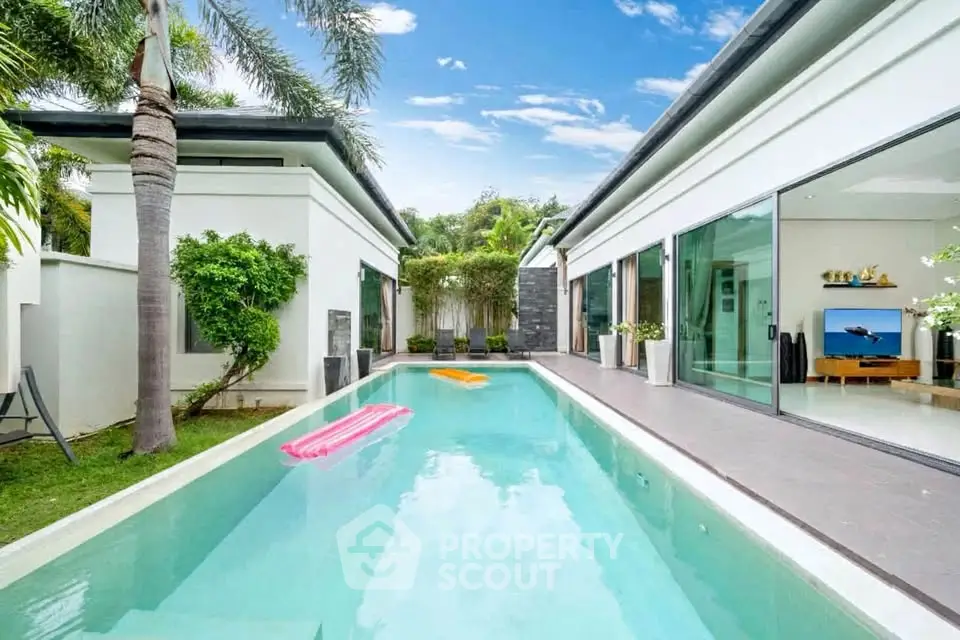 Luxurious modern villa with private pool and lush garden, perfect for relaxation and entertainment.