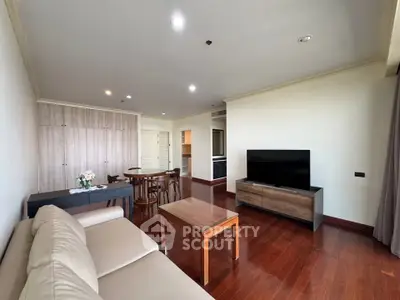 Spacious living room with modern furniture and wooden flooring in a stylish apartment.