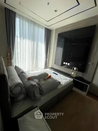 Modern bedroom with large window and stylish decor in a luxury apartment.