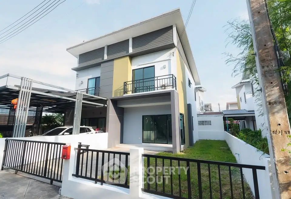 Modern two-story house with sleek design and spacious driveway in a suburban neighborhood.