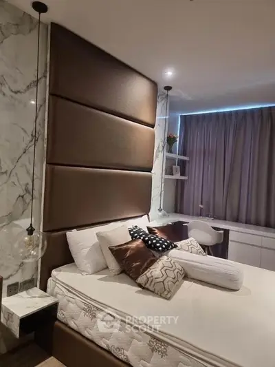 Luxurious bedroom with elegant decor and plush bedding in modern apartment.