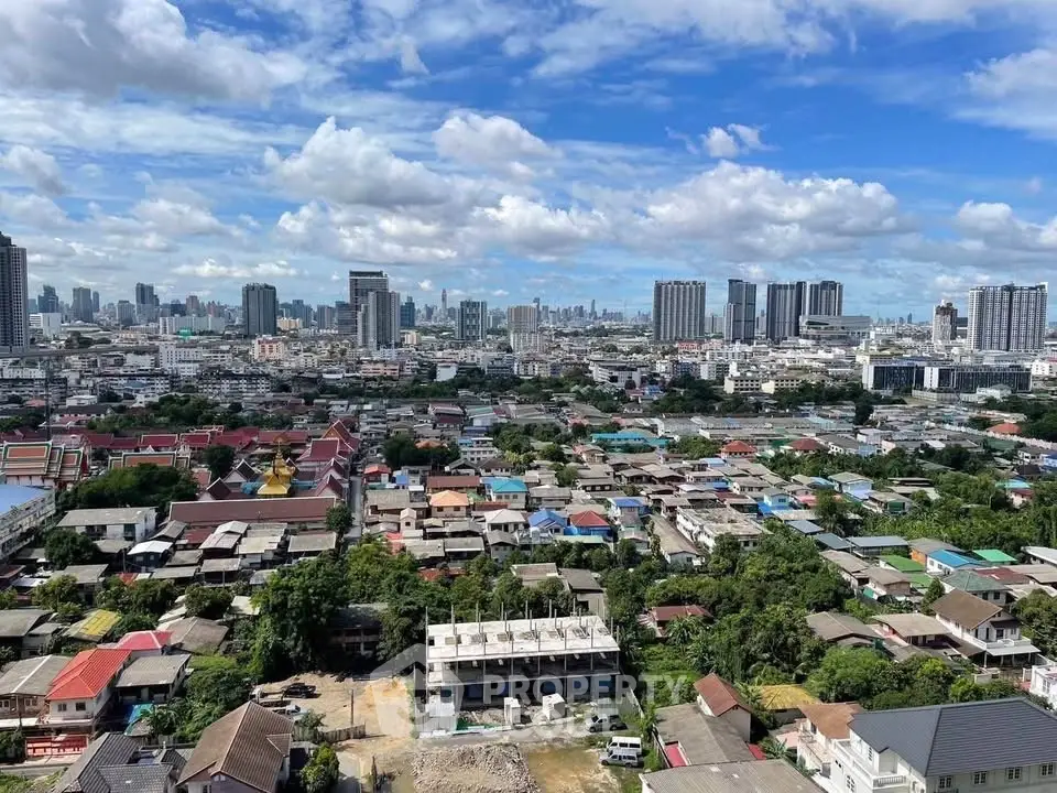 Stunning cityscape view showcasing urban skyline and residential areas under a vibrant blue sky.