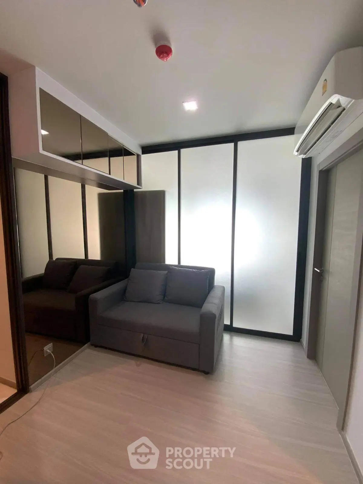 Modern living room with sleek design and comfortable sofa in a compact space.