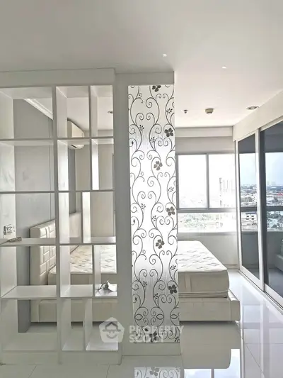 Modern bedroom with decorative partition and city view, featuring sleek design and natural light.