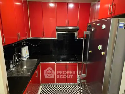 Modern red kitchen with sleek cabinets and stainless steel appliances