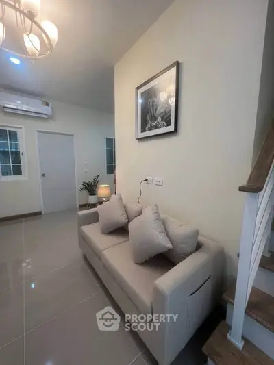 Modern living room with cozy sofa and elegant decor in a stylish home interior.
