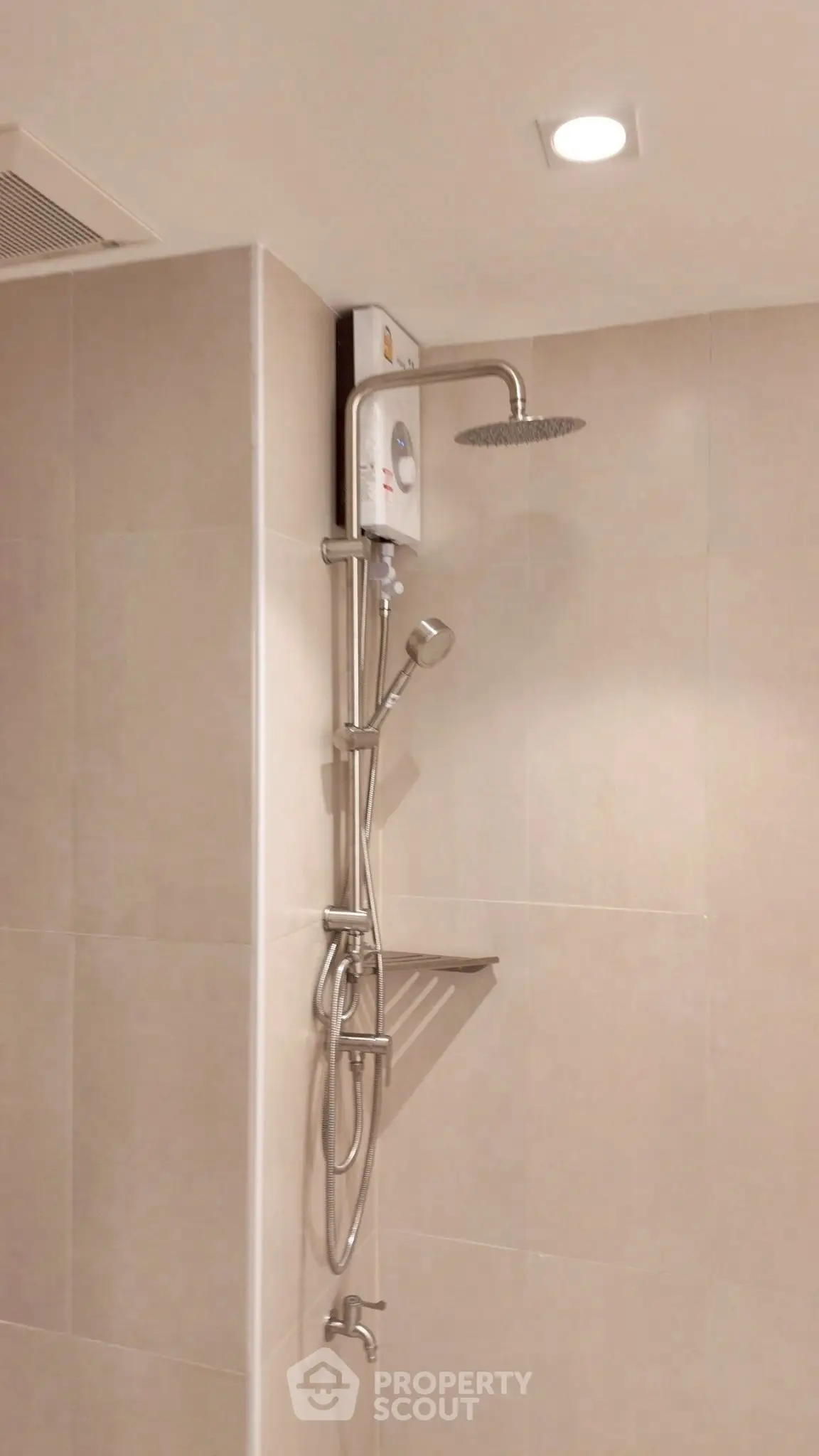 Modern bathroom with sleek shower fixtures and neutral tile design.