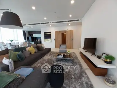 Luxurious modern living room with plush seating and open kitchen layout