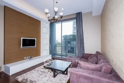 Modern living room with plush purple sofa and balcony view