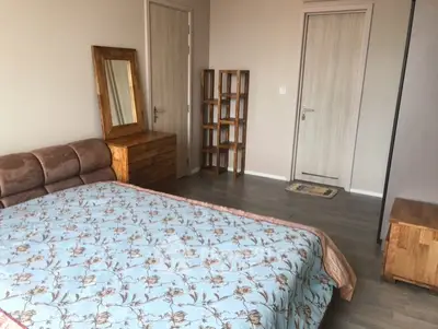 Spacious bedroom with elegant wooden furniture and stylish decor