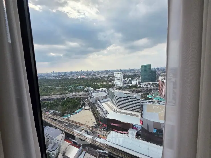 Stunning cityscape view from high-rise apartment window with expansive skyline and modern architecture.