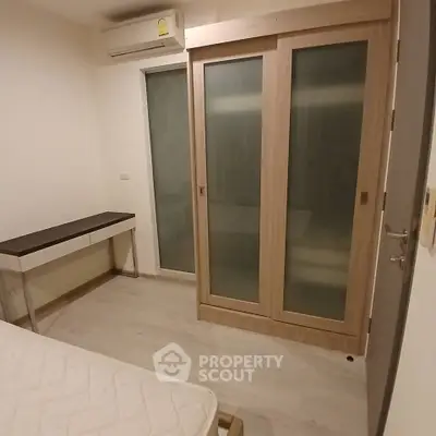 Cozy bedroom with sliding wardrobe and air conditioning in modern apartment