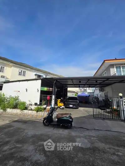 Charming suburban home with spacious driveway and modern carport, perfect for family living.