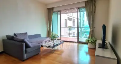 Spacious living room with modern decor and large balcony view