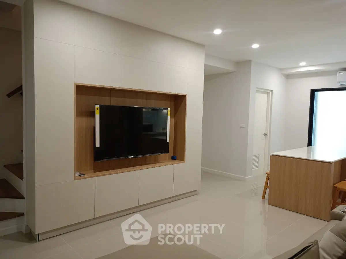 Modern living room with built-in TV unit and sleek design